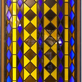 Decorative glass window with polychrome geometric shapes  