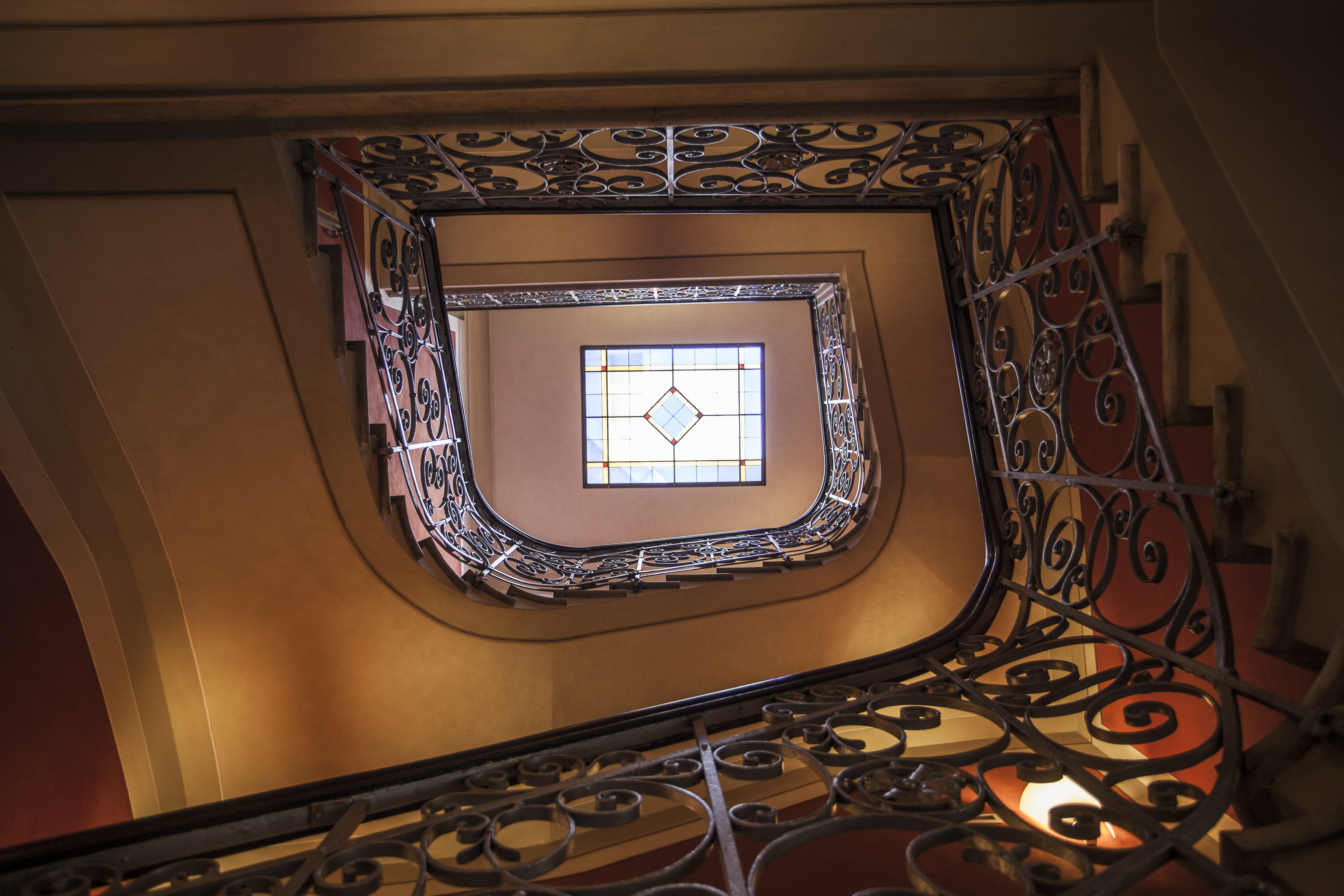 The main staircase with a silver tread iron railing, viewed from below