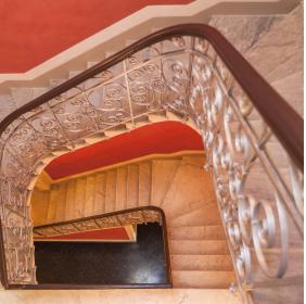 The main staircase with a silver tread iron railing, viewed from above